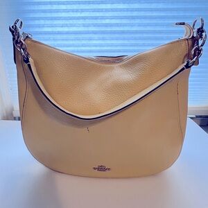 Coach pebble leather pale yellow hobo shoulder bag.